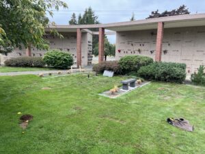 Lawn area in front of a brick mausoleum before construction.